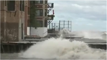 Waves flooding end of street in Rogers Park